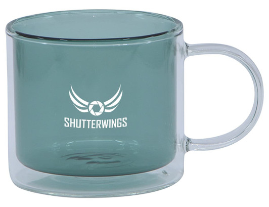 A double wall mug in a teal colour with a transparent handle, featuring a logo on one side.
