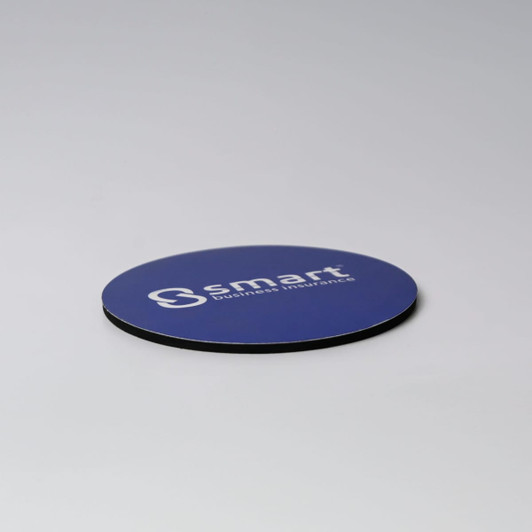 A round blue coaster with a black edge and a logo on the surface.