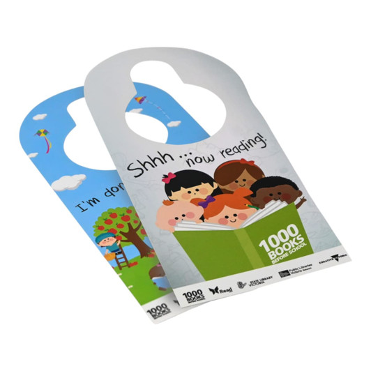 A double-sided door hanger featuring colourful illustrations of children and nature, with playful text and a logo.