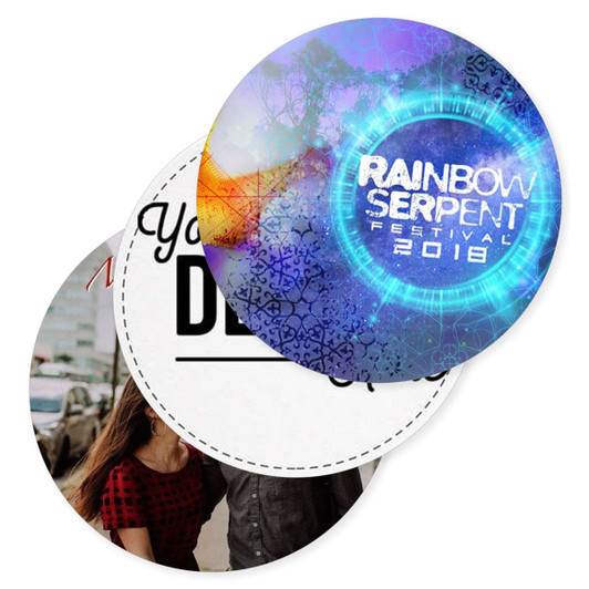 A set of round cardboard coasters featuring colourful designs and a logo, one with a festival theme and the other with a photo.