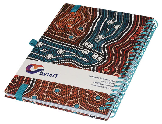 A side-bound A5 notebook featuring a colourful, patterned cover and a blue spiral binding. It includes a logo.