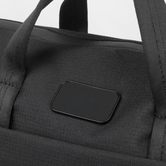 A black computer bag with sturdy handles and a branding logo on the front.