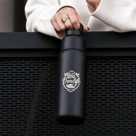 A drink bottle in matte black with a logo, featuring a twist lid and a durable design.
