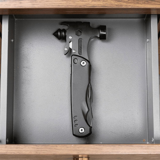 A black survival hammer with multiple tools, displayed in a grey drawer. It features a sleek design and a branding logo.