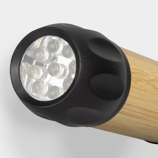A bamboo torch with a black plastic end featuring multiple LED lights. It has a simple, natural design.