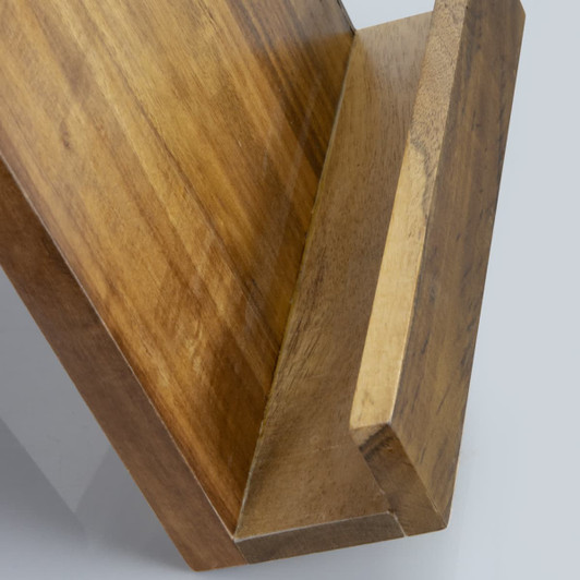 A wooden recipe book holder in a warm tone, featuring a slanted design for easy page viewing.