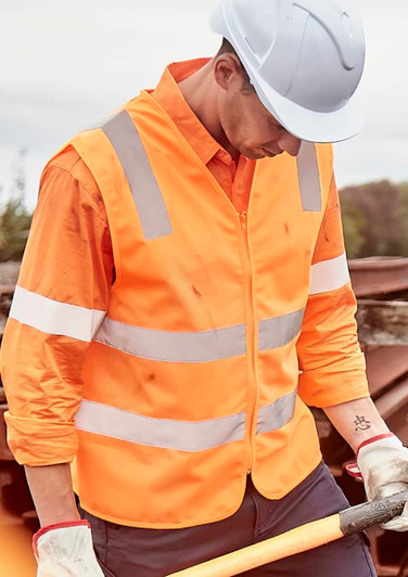 An orange unisex hi-vis vest with silver reflective strips, worn over a long-sleeve shirt, featuring a safety helmet.
