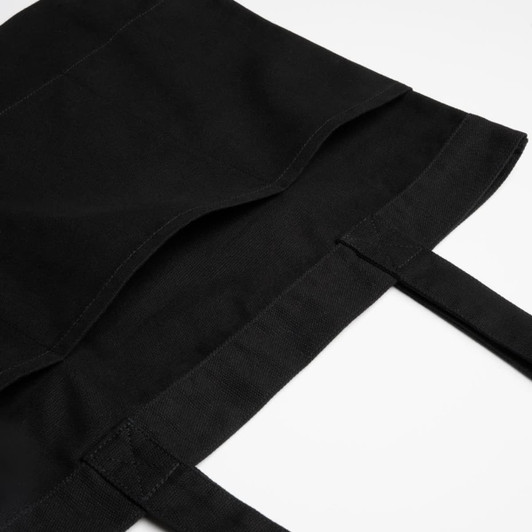 A black tote bag with reinforced handles and a fold-over top, featuring a simple design and a logo.