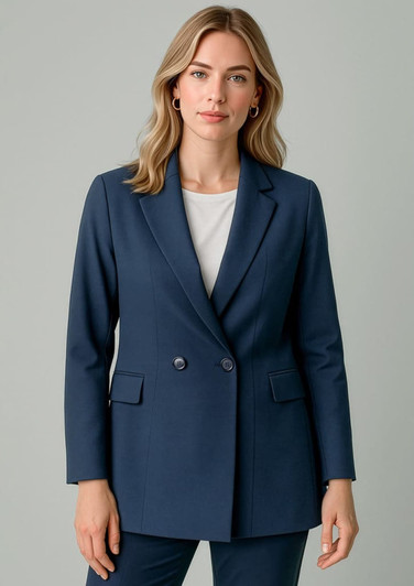 A navy double-breasted longline jacket featuring two front pockets and a tailored fit. The model is wearing a white top underneath.