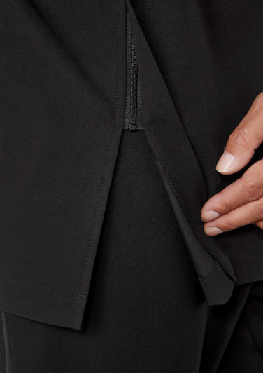 A close-up of a black jacket featuring a zippered opening and a hand demonstrating the detail.