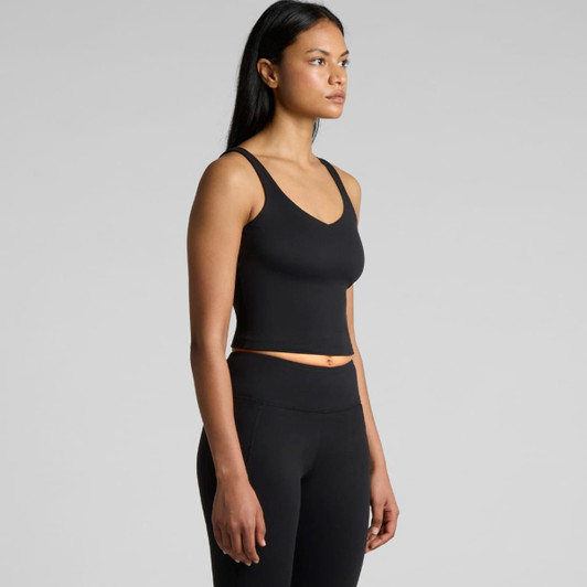 A black active bra tank with a V-neckline, displayed on a model in a side profile view, showcasing its fitted design.