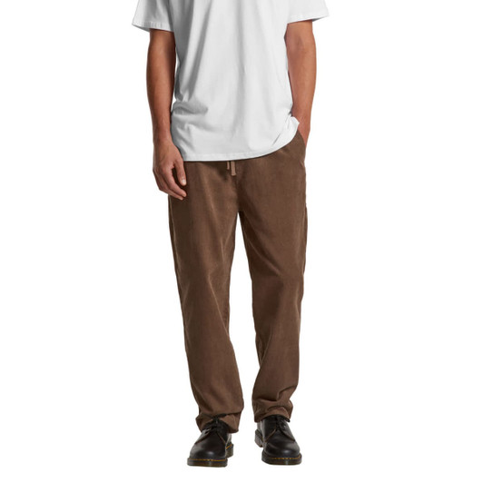 Brown cord pants worn with a white T-shirt, featuring side pockets and a drawstring waist.