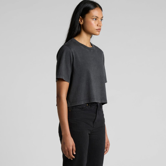 A cropped heavy tee in a stone wash grey, worn with black high-waisted jeans. The top has a logo on it.