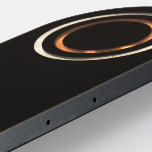 A dual wireless charger in black with a circular design and a metallic accent, featuring a logo.