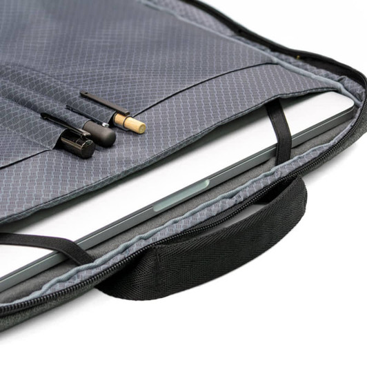 A grey laptop case featuring an interior pocket and compartments for accessories, including pens. It has a handle and branding.