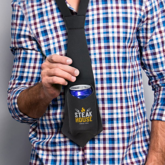 A drink bottle is held in a black stubby holder styled as a tie, featuring a logo, against a checked shirt backdrop.