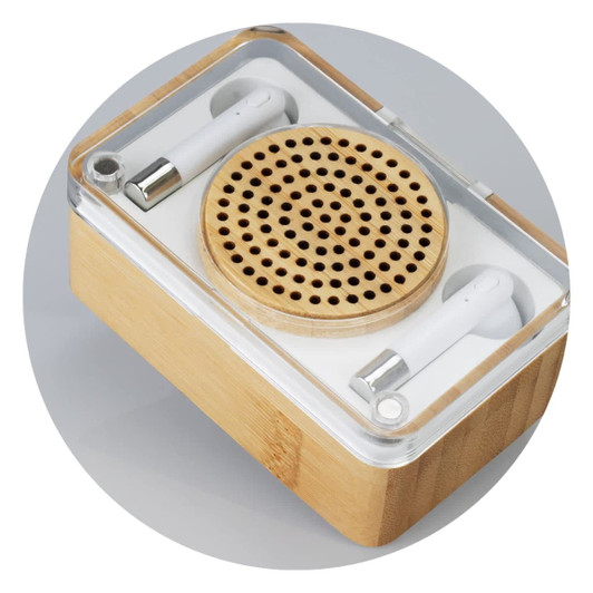 Bamboo wireless speaker and white earbuds set, displayed in a clear case with a wooden base.