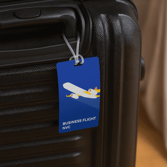 A blue imprinted large luggage tag attached to a black suitcase handle, featuring a graphic of an airplane.
