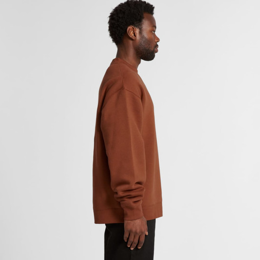 A brown sweater displayed on a model from the side view, featuring a relaxed fit and long sleeves.
