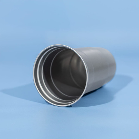 A drink cup made of recycled aluminium, featuring a sleek silver design with a smooth interior.