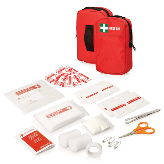 A red first aid kit with two zipped pouches and various first aid supplies including bandages, scissors, and sterile dressings.