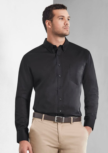 A men's long sleeve shirt in black, featuring a button-down front and a chest pocket. Includes a logo.