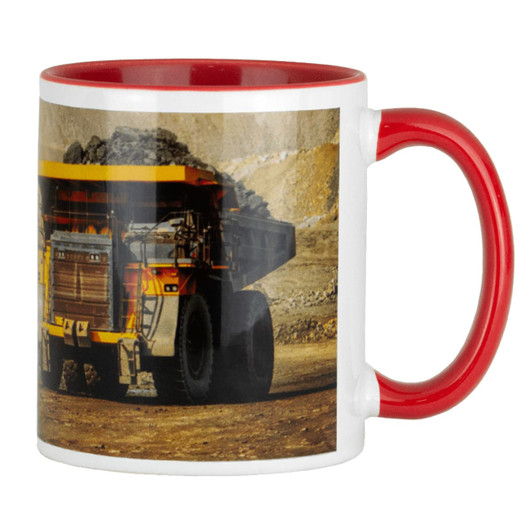 A ceramic mug featuring a red handle and interior, displaying an image of a mining dump truck.