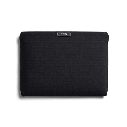 A black laptop sleeve featuring a logo, designed to fit a 16-inch laptop.