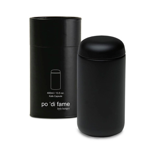 A black drink bottle in a matching black cylindrical container, featuring a logo on the side.