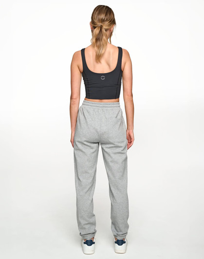 A person wearing grey unisex airlayered CVC sweatpants from a rear view, paired with a dark crop top.