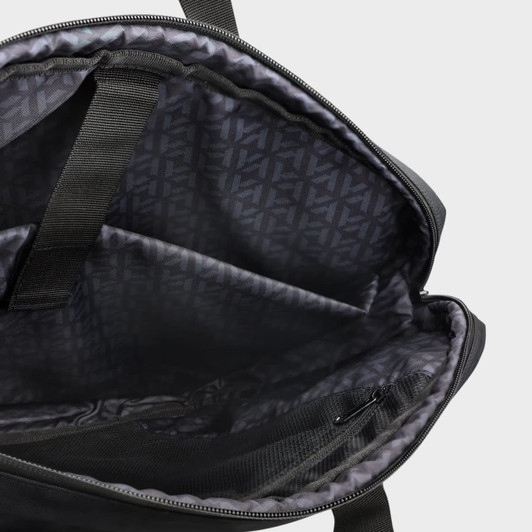 An interior view of a black laptop bag featuring multiple compartments and a patterned lining.