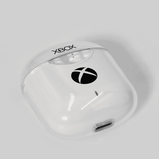 A pair of white earphones in a clear case, featuring a logo on the front.