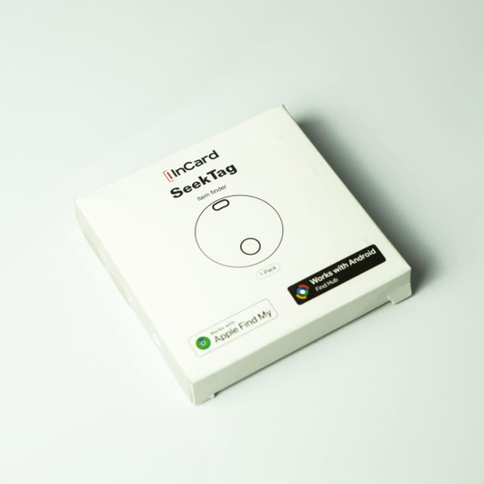A white box containing the SeekTag Dual System Item Tracker, featuring a circular item tracker inside.