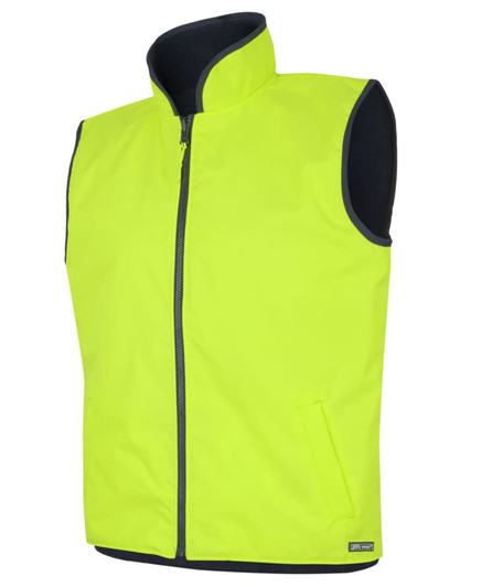 A reversible vest in high-visibility yellow, featuring a zip front and side pockets, with a contrasting black lining.