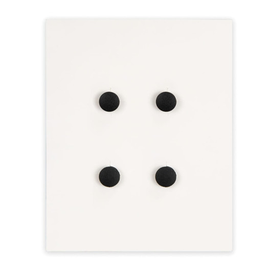 Four round black shoe charms arranged on a white backing. The display features a simple design with a clean aesthetic.