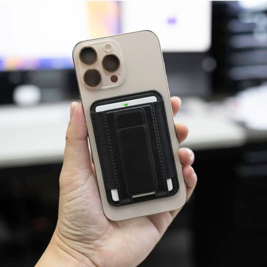 A smartphone with a black cardholder attachment, featuring a sleek design and a neutral-coloured case.