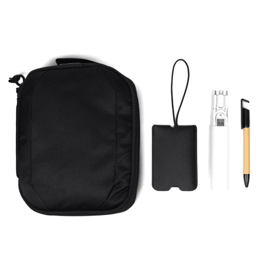 A black travel pack with a drink bottle, a pen, a cardholder, and a small strap accessory.