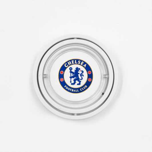 A circular glass ashtray featuring a logo in blue and white for a football club, with a silver rim.
