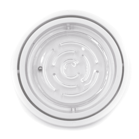 A circular fidget toy in clear plastic featuring a spiral maze design with a small ball inside.