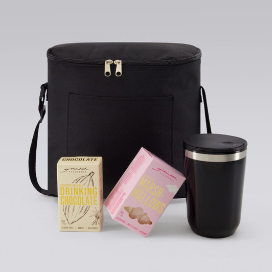 A black insulated bag with a drink tumbler and two boxes of chocolate and marshmallow products.