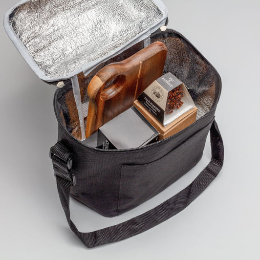 A black cooler bag with a silver insulated interior, containing a wooden cutting board and packaged food items.