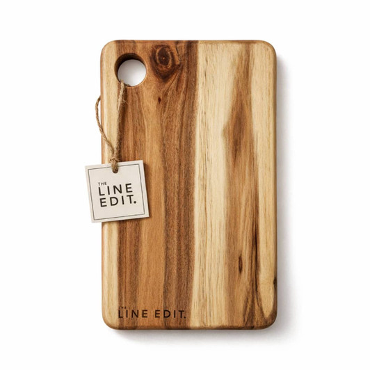 A wooden serving board with a natural finish and a circular cut-out, featuring a brand tag.