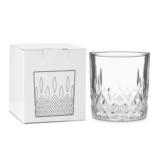 A crystal drink tumbler beside a white box with a simple geometric design. The tumbler is clear and features a faceted base.
