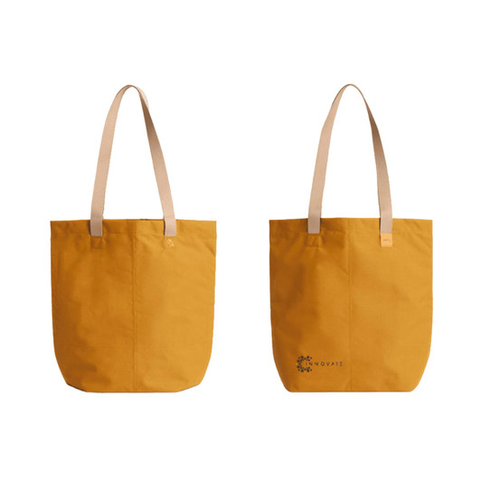 A yellow tote bag with light-coloured straps and a logo on one side. Simple and stylish design.