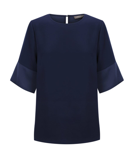 A navy top with contrasting cuff sleeves and a round neckline, featuring a keyhole back. It has a logo on the label.