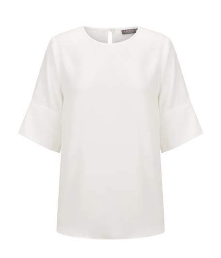 A white shirt featuring three-quarter bell sleeves and a back keyhole opening, with a branding logo.