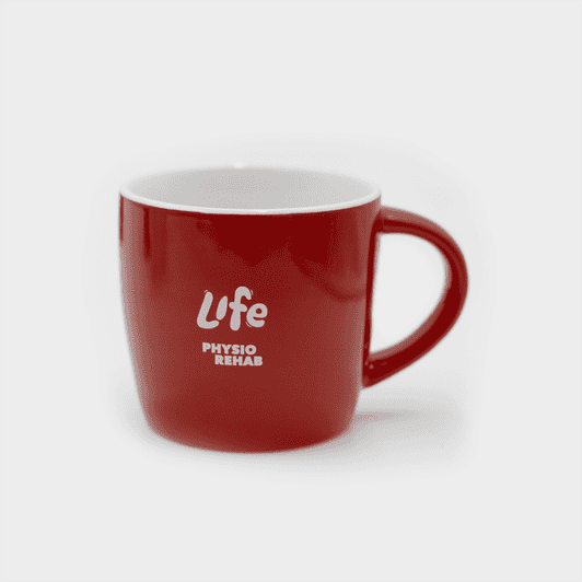 A ceramic mug in vibrant red with a white interior, featuring a logo on the side.