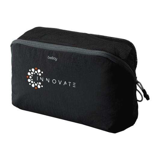 A black packing cube with a mesh panel and a logo on one side, designed for organizing travel items.