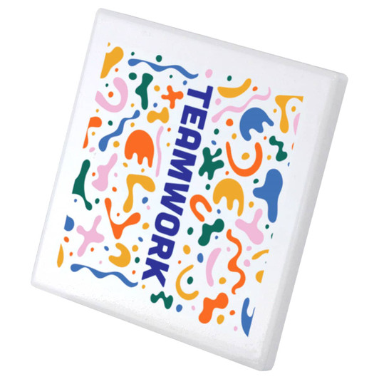 A square ceramic coaster featuring a vibrant, abstract design in multiple colours with the word "TEAMWORK."