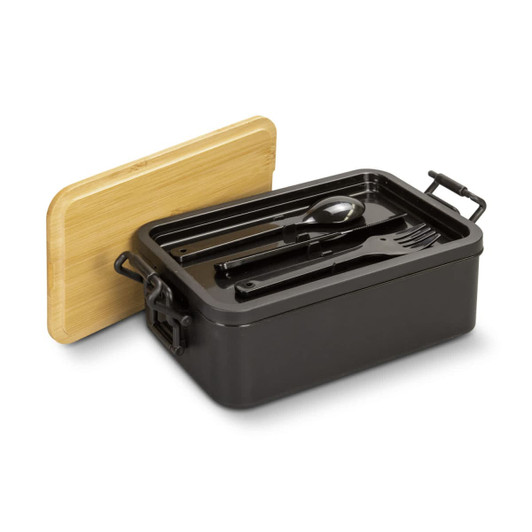 A black expandable lunch box with a bamboo lid, containing utensils: a spoon, fork, and knife.